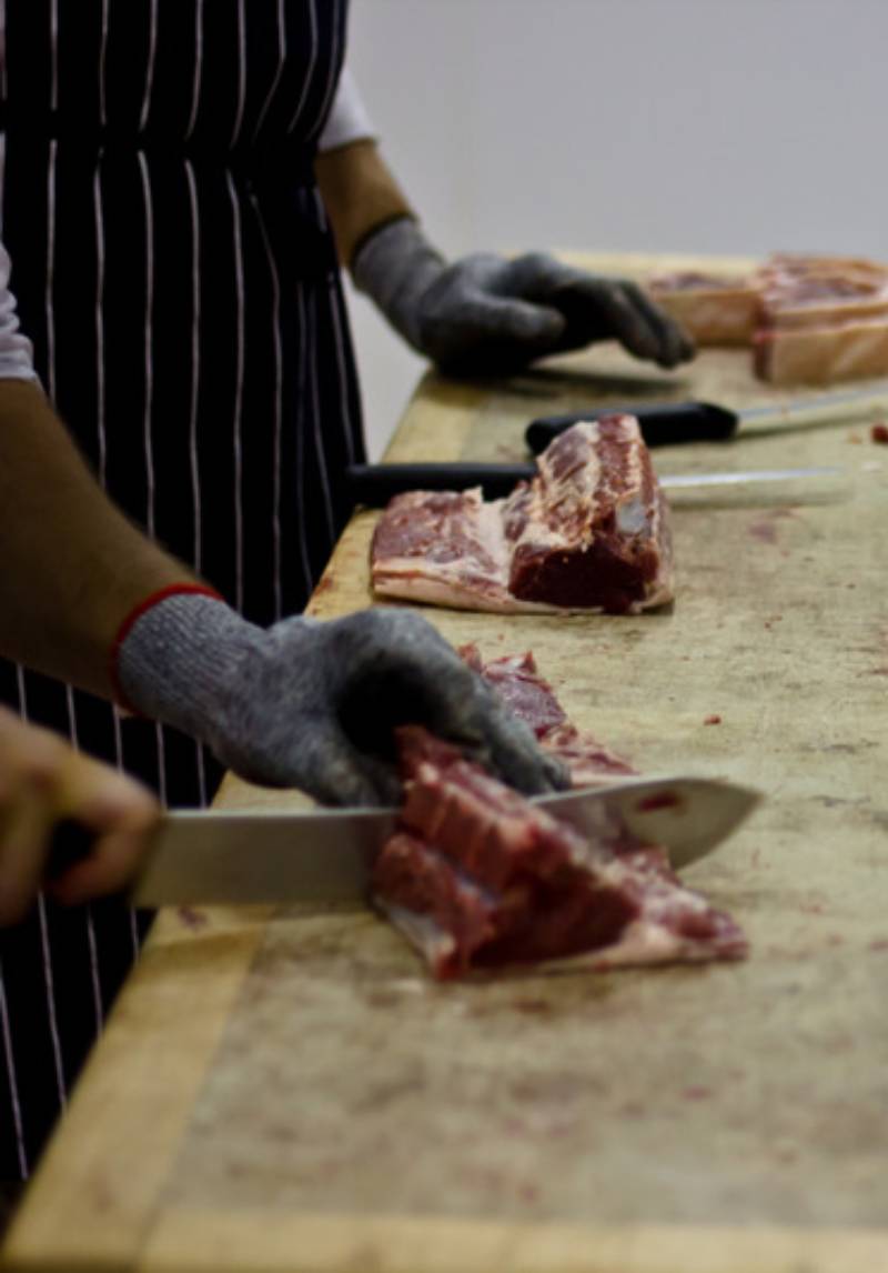 butcher cutting meat